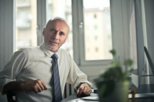 Older man with tooth crowns from Dr. Vakay in Centreville