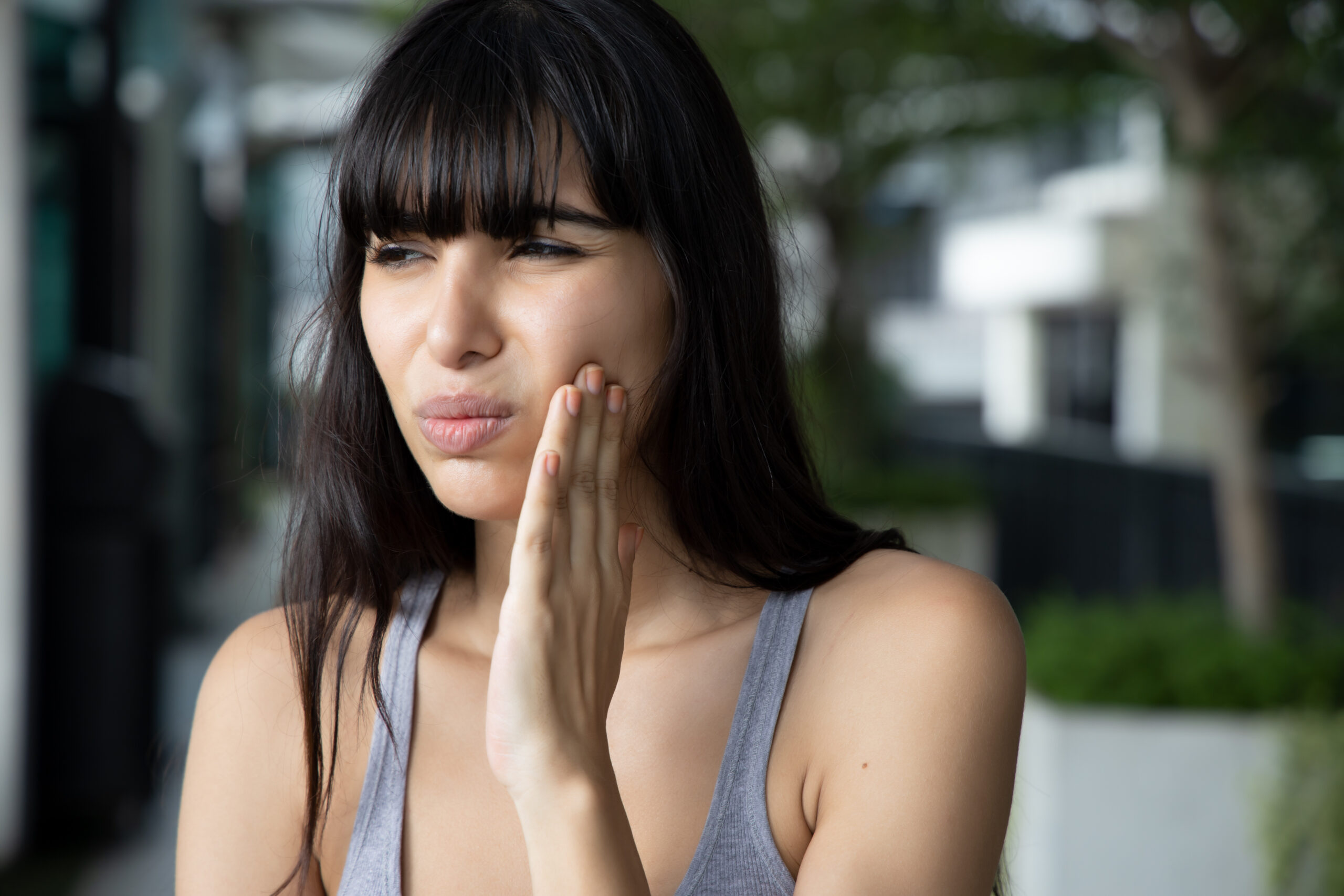 young woman suffering from wisdom tooth pain
