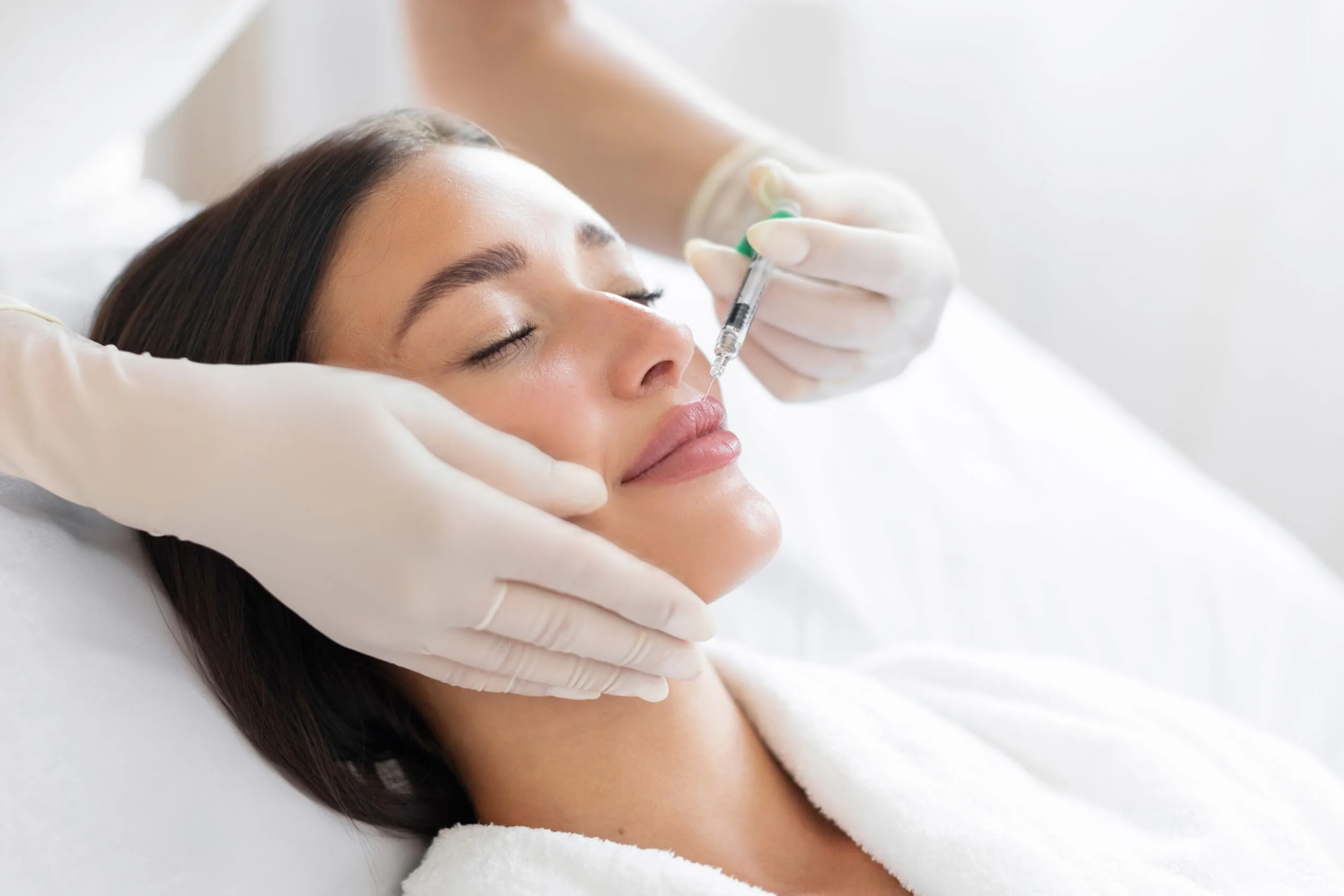 doctor injecting botox near a female patients mouth