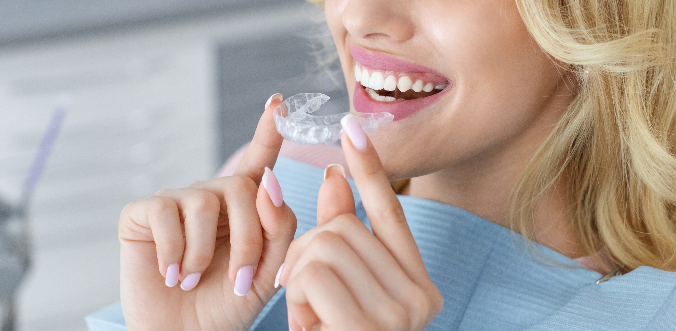 closeup of a woman putting in clear aligner